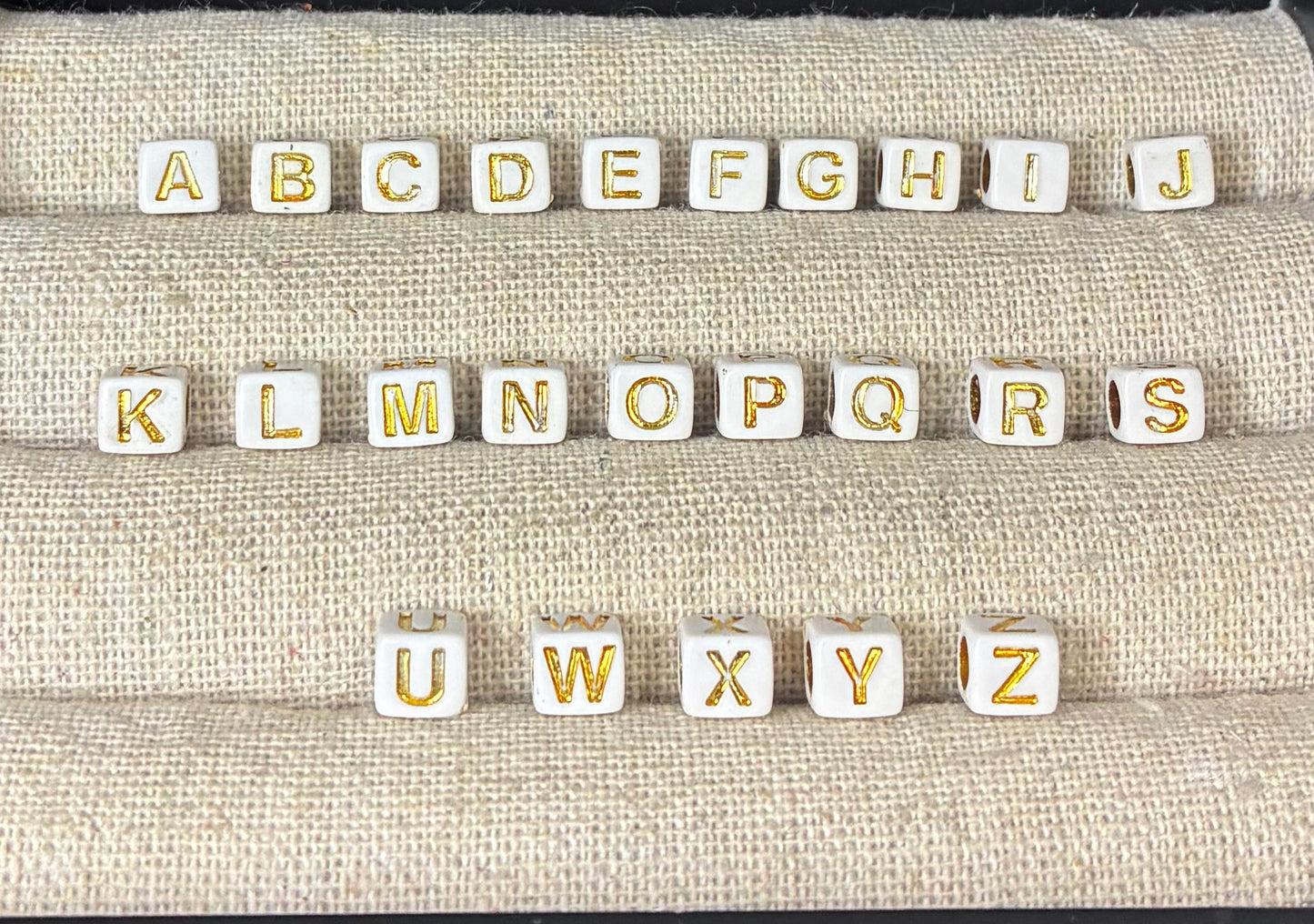 White and gold alphabet beads