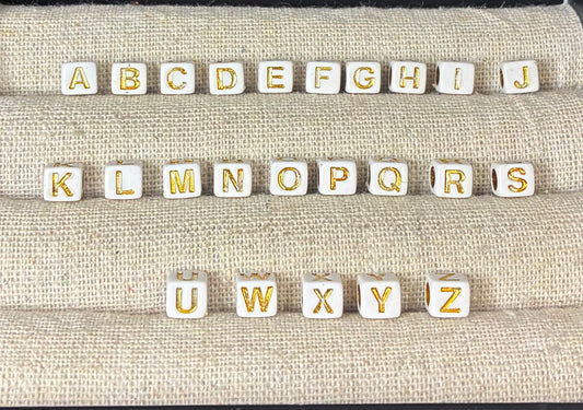 White and gold alphabet beads