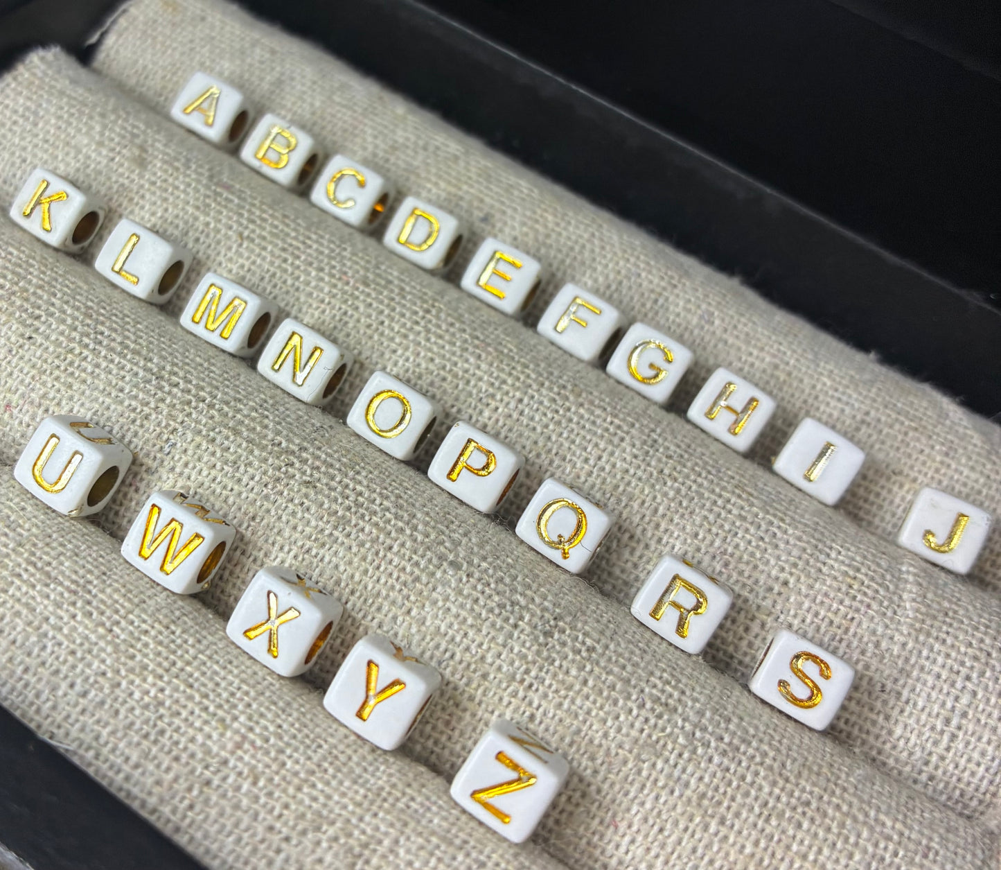 White and gold alphabet beads
